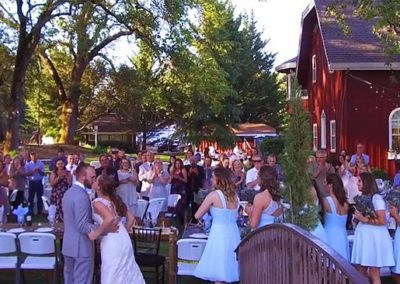 Outdoor wedding reception cheers as couple kiss at Rough & Ready Vineyards Nevada County’s Favorite Vineyard Wedding Venue