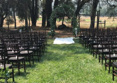Photo of an Intimate wedding set up under the oaks