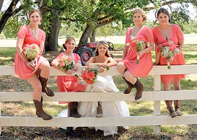 A summer bride and her bridesmaids dressed for the weather