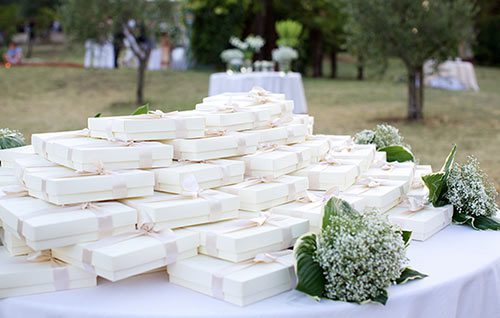 Table of white-wrapped unique wedding favor ideas