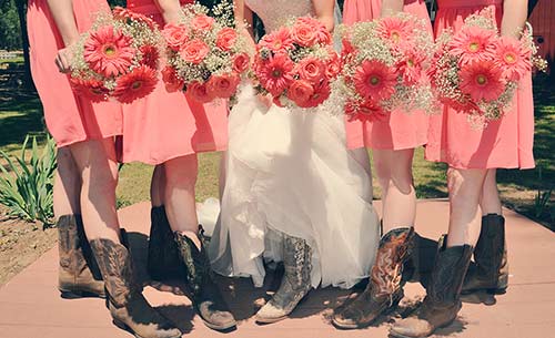 Four bridesmaids and the bride pose with their summer wedding bouquets