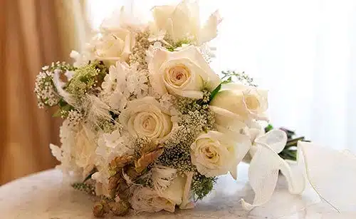 Wedding bouquet of white roses mixed with other florals