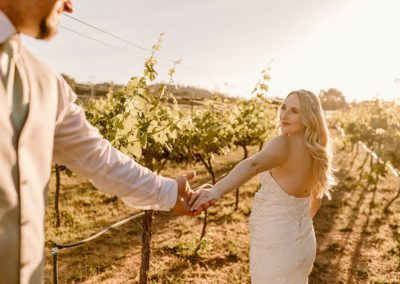 Wedding couple enjoy a walk in the vineyard