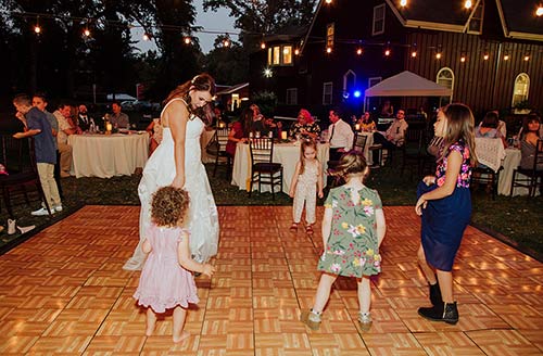 The bride dances with her smallest wedding guests on her guest list. Photo by Athena Kalindi Photography
