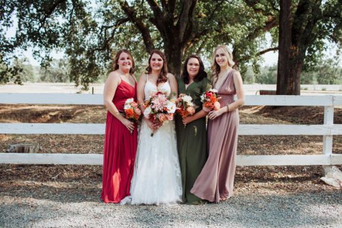 A bride and her three bridesmaids posed for a photo by Athena Kalindi Photography at the Rough & Ready Vineyards