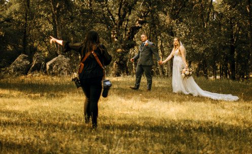 Photographer Kayla Ashton Webb directs a bride and groom at the Rough and Ready Vineyards