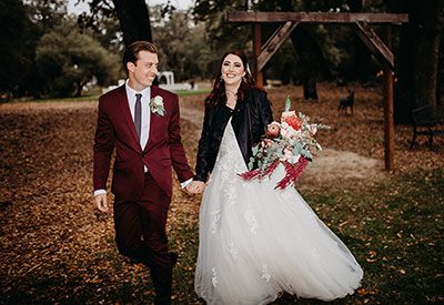 Rebekah Townley Photography took this photo of a bride and groom entering their reception