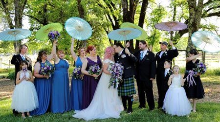 Wedding party holding parasols, photo by Darling Photography
