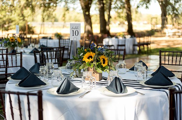 Guest table with navy blue and sunflowers by Engstrom Photography