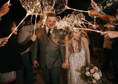Bride and Groom Leaving under Balloon Lights