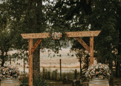Wedding arbor with flower barrels