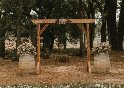 wooden wedding arbor wine barrels blush colored