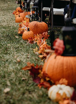 Photo of pumpkins and leaves in a wedding aisle by Rebekah Townley Photography