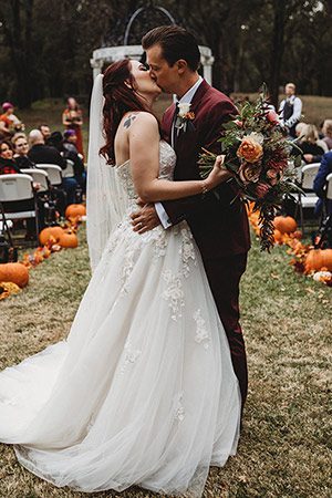 Bride and groom kissing at their fall wedding. Photo by Rebekah Townley Photography