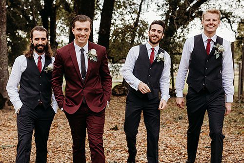 A groom taking a walk with his groomsmen. Photo by Rebekah Townley Photography