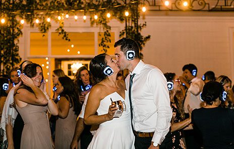 Bride and groom kiss during their wedding reception