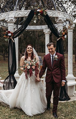 Newly-wedding couple with wine-themed colors incorporated into their theme. Photo by Rebekah Townley