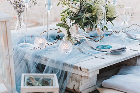 A repurposed pallet provides the base for an elegant table setup in blue pastels