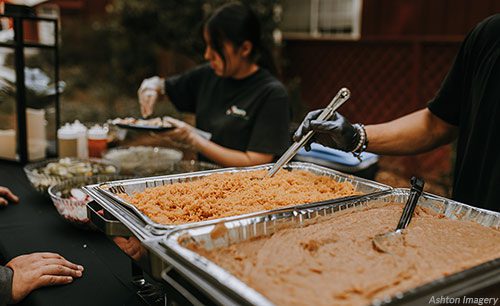 Photo of catering staff serving Mexican food taken by Ashton Imagery