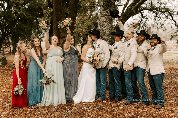 A bride, groom, and their wedding party celebrate after fulfilling their bridal party roles. Photo by Lela Spiva Photography