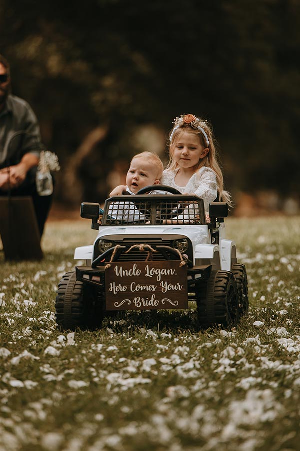 flower girl and ring bearer driving Jeep