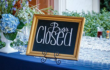 Chalkboard sign that reads 'Bar Closed' at a wedding reception