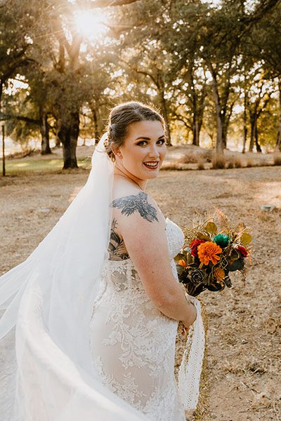 Bride in front of oaks