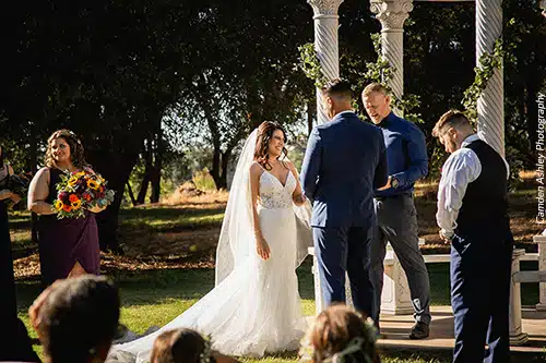 A bride enjoys herself during the wedding ceremony. Photo by Camden Ashley Photography