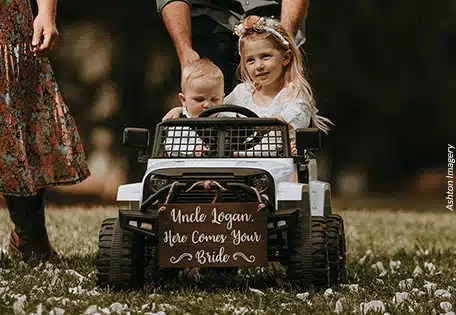 A very young ring bearer and flower girl about to travel up the aisle in style. Photo by Ashton Imagery