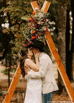 A bride and groom having their first kiss as a married couple at Rough & Ready Vineyards. Photo by Lela Spiva Photography