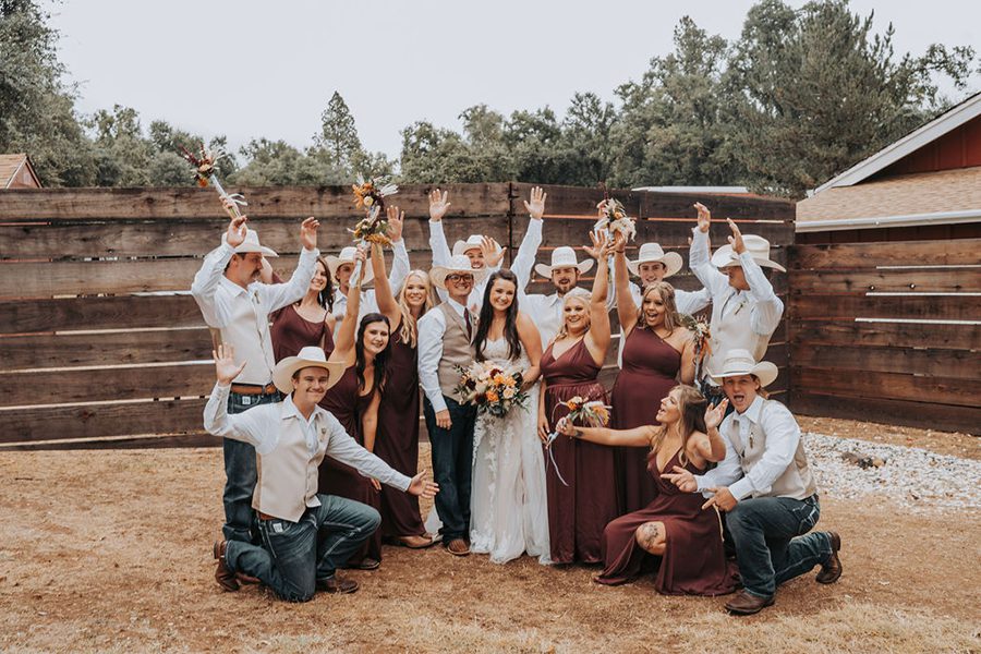 Shelby Ryan and their wedding party celebrate