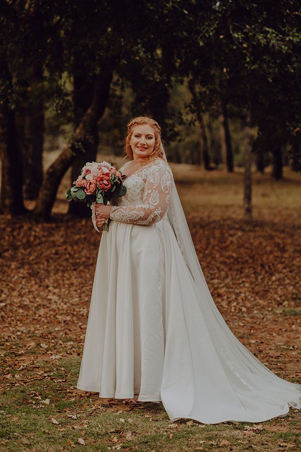 Bride smiling with her bouquet of beautiful flowers