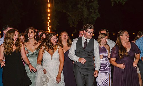 Shawna and Lucas having fun on the dance floor with their wedding guests. Photo by Mindful Media Photography