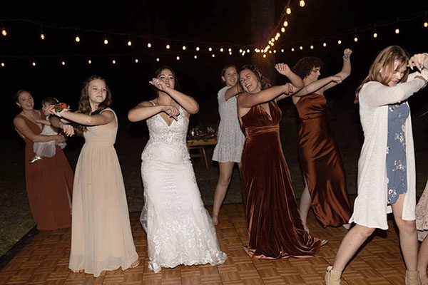 The bride, bridesmaids, and female guests dancing. Photo by Rebekah Townley Photography