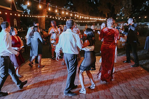 Wedding guests enjoy dancing under the market lights. Photo by Ashton Imagery