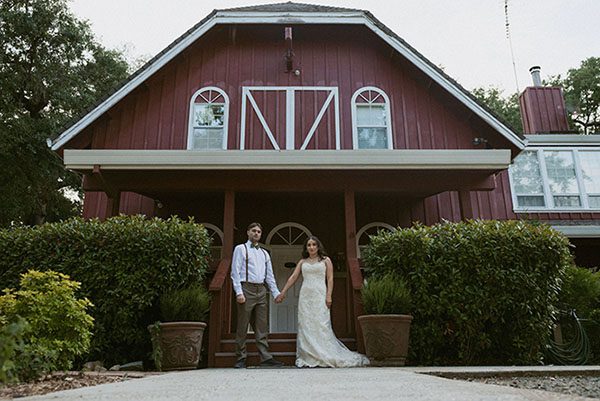 Bride and groom holding hands in front of the Rough & Ready Vineyards Guesthouse. Photo by Heidi Peinthor Photography