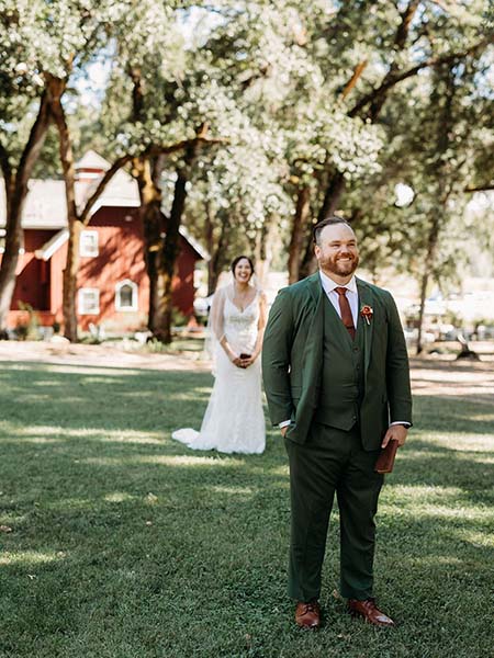 Bride walking up to her groom for their first look moment. Photo by Rebekah Townley Photography