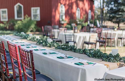 Tables and chairs arranged for a wedding reception at the Rough & Ready Vineyards. Photo by Elizabeth Jane Photography
