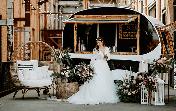 Bride enjoying a drink in front of Little Boozy Mobile Bar Co.'s "Rita aka Salud!" trailer. Photo by James Young Photography