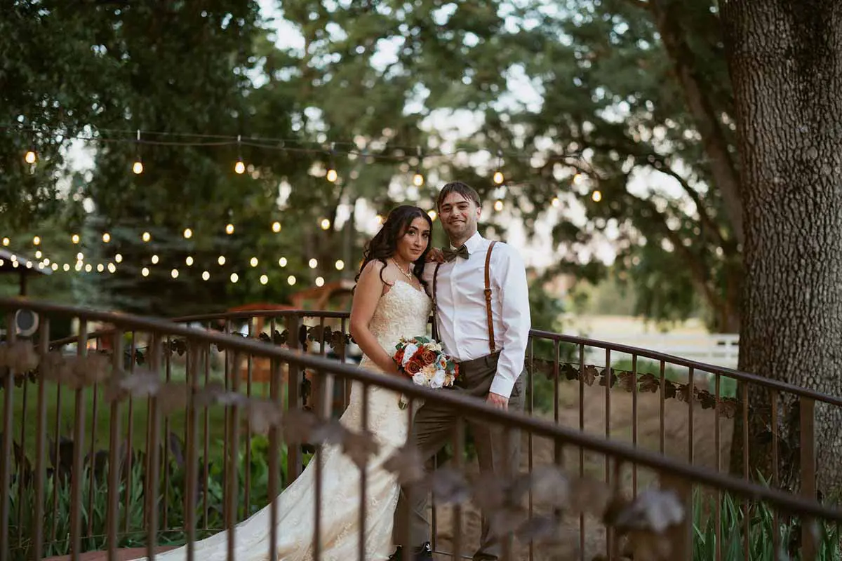 Bride holding up bouquet while leaving gazebo