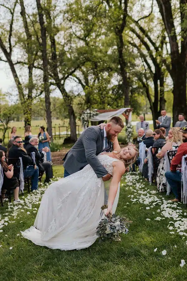 dip-dt Timothy "dips" Danielle at the end of the aisle