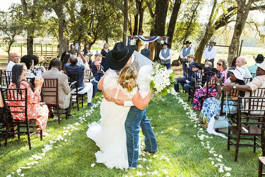 RondaMichaelkiss Bride and groom kissing after ceremony at Rough and Ready Vineyards