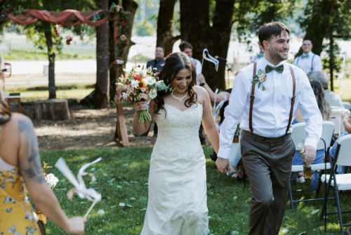 Joyous couple walk down the aisle after planning their wedding in northern California