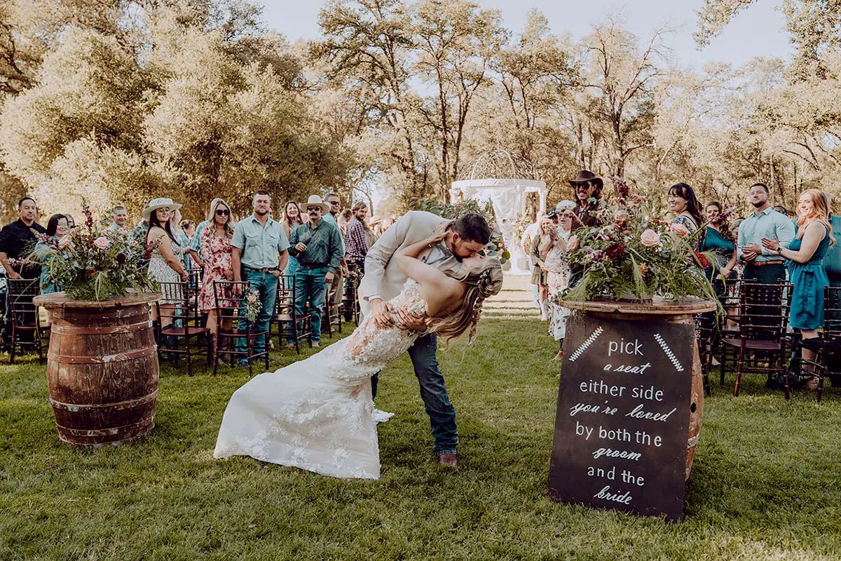 Kasey and Maddy kiss at the end of the aisle. Photo by Dream Capture Studios