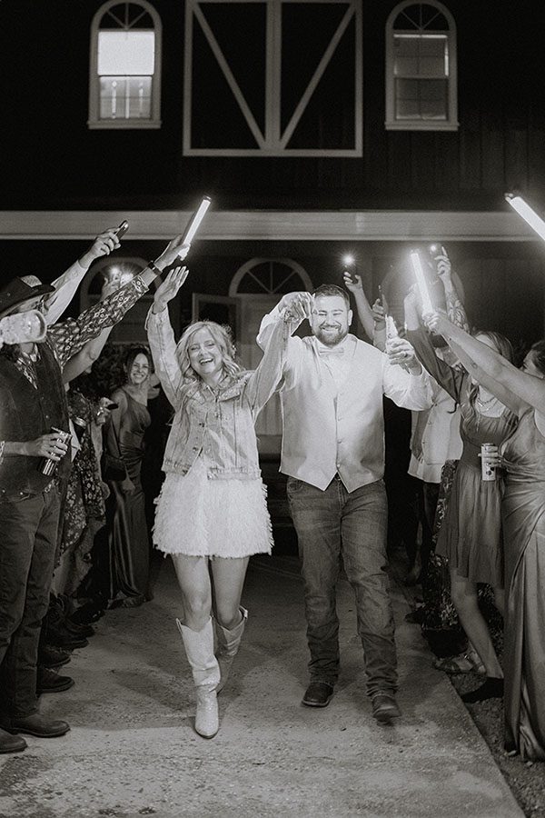 wedding party lights the path for Maddy and Kasey. Photo by Dream Capture Studios