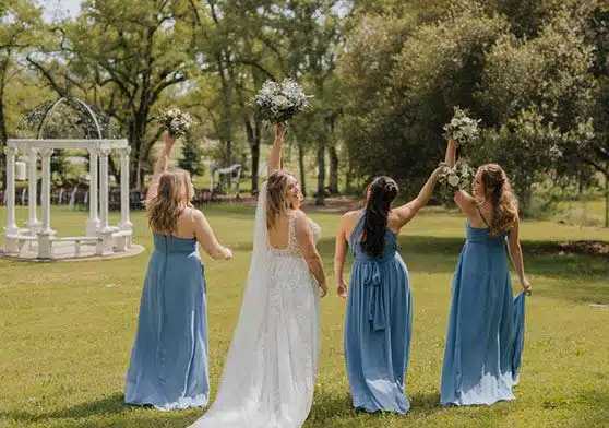 A bride and her bridesmaids having fun at Rough & Ready Vineyards. Photo by Taylor Benedickt Photography