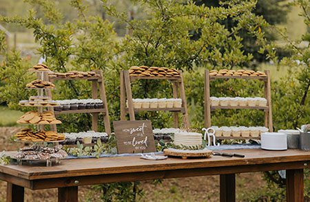 Dessert table at an outdoor wedding. Photo by Taylor Benedickt