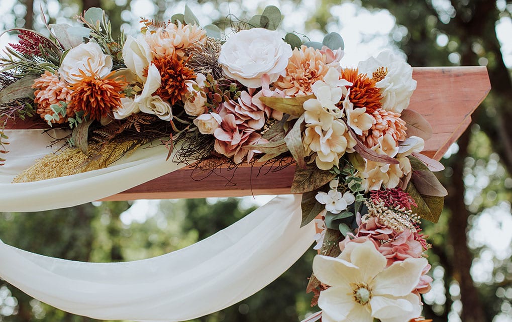 flowers decorate wedding arch in springtime, perfect for a 2027 Rough and Ready Vineyards wedding