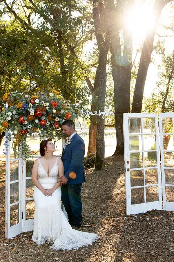 JaimieTravis by windows bride and groom by windows at Rough and Ready Vineyards