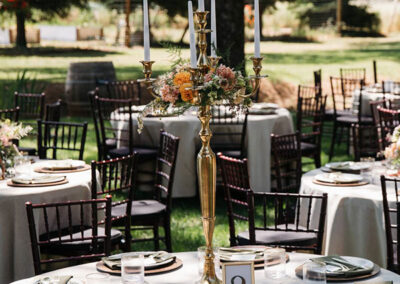 Reception tables beautifully decorated under the oaks